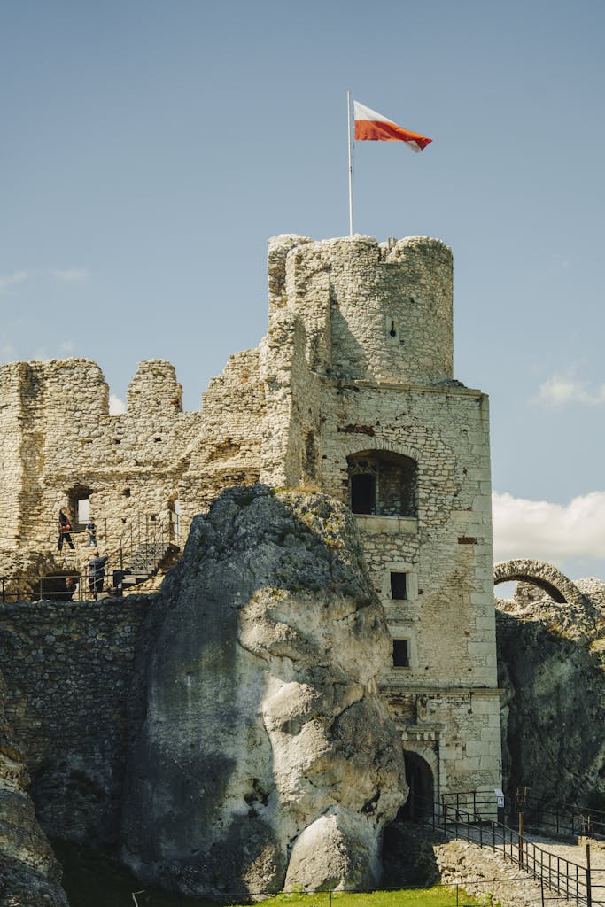 Explore the historic Ruins of Ogrodzieniec Castle in Podzamcze, Poland, under a clear blue sky.