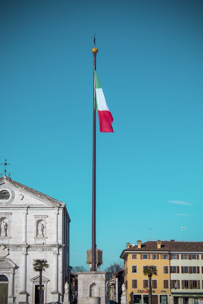 View of the Italian flag waving in central Palmanova's historic piazza in Italy.